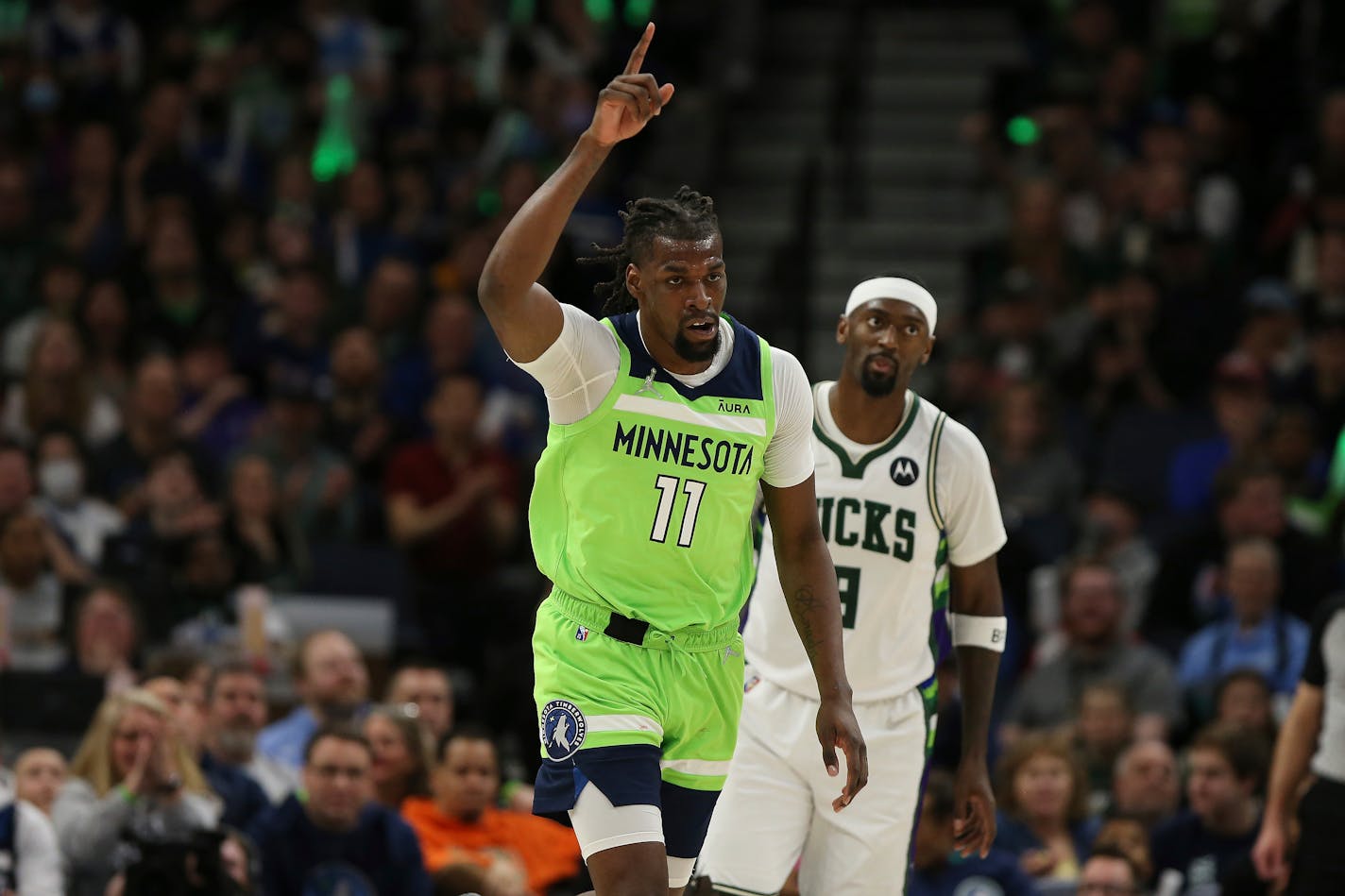 Timberwolves center Naz Reid reacts after scoring a basket during the first half against the Milwaukee Bucks.