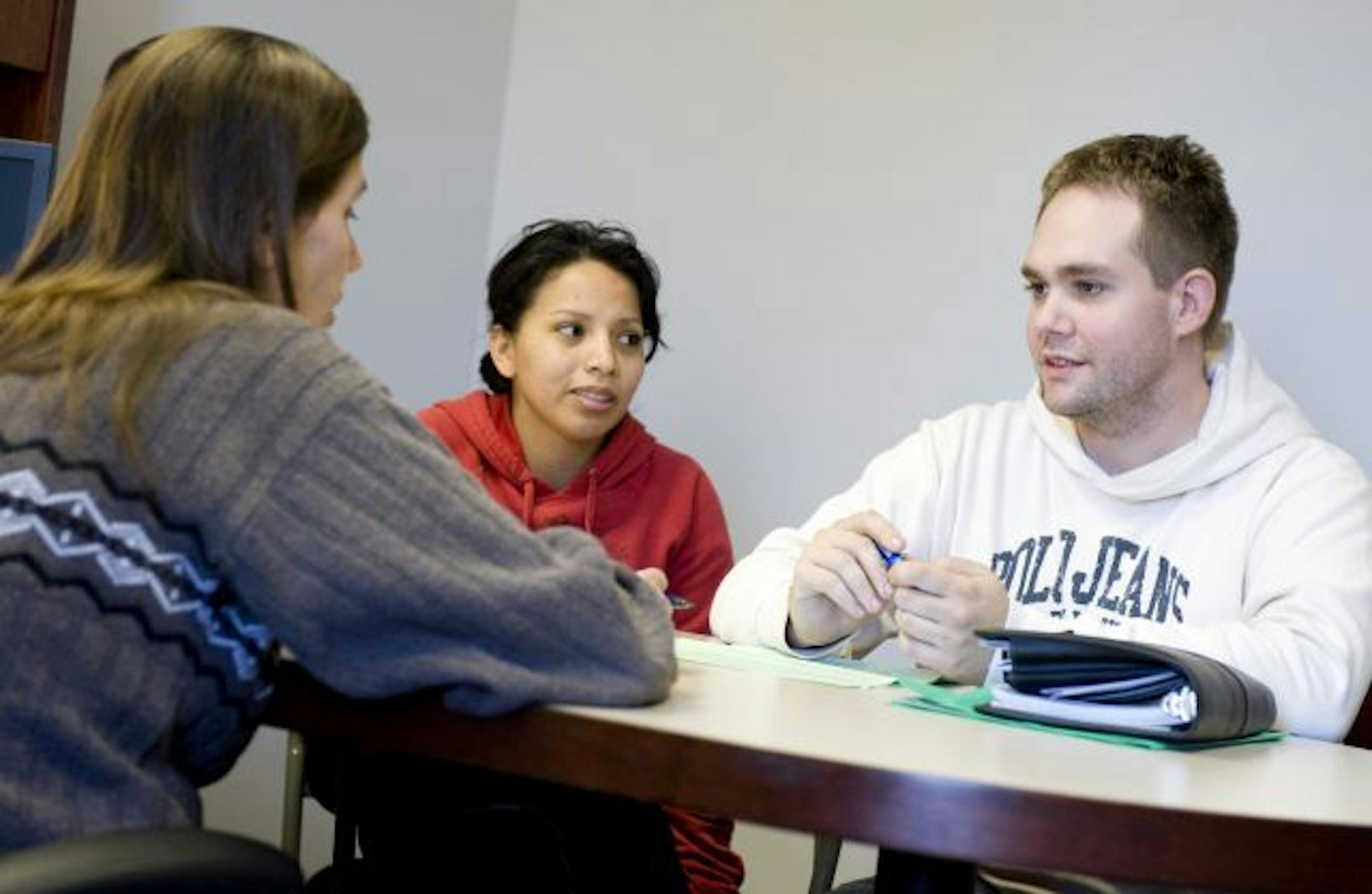 Jennifer Romero, left, helped John McDonald and his girlfriend, Marleny Lakin, apply for energy assistance Thursday at Community Action Partnership of Suburban Hennepin. McDonald has been laid off for 18 months. Like many applicants, he is seeking help for the first time in his life.