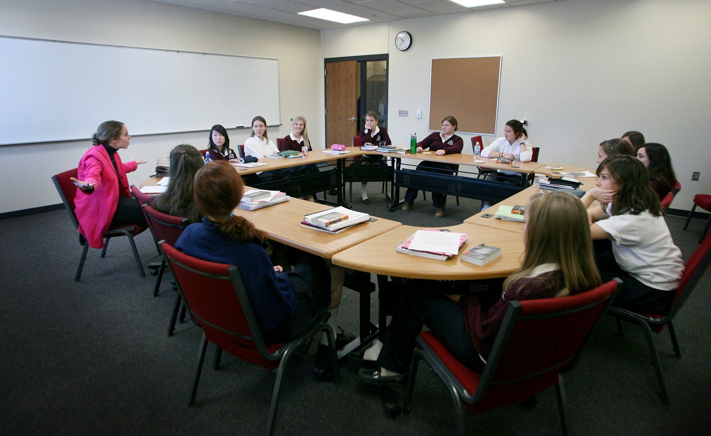 Humane Letters teacher Gwen Adams, far left, led senior girls in discussion in a seminar room during the first day back to school for students at Trinity School, a private school with grades 7 through 12. The school has 370 students.