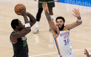 Julius Randle (30) of the Timberwolves is defended by Kenrich Williams (34) of the Oklahoma City Thunder in the third quarter at Paycom Center in Okla