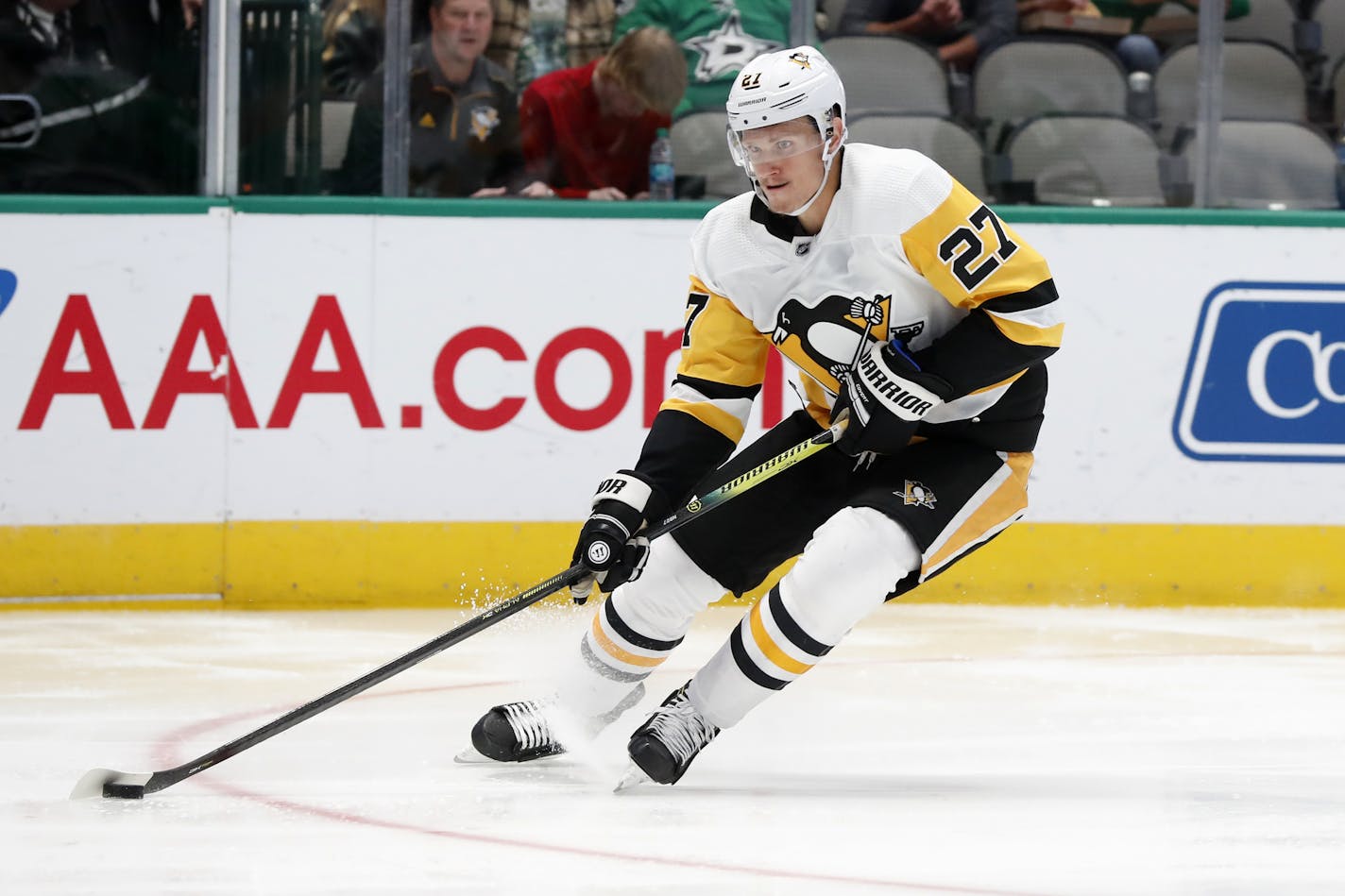 Pittsburgh Penguins center Nick Bjugstad (27) controls the puck before taking a shot at the net during an NHL hockey game against the Dallas Stars in Dallas, Saturday, Oct. 26, 2019. (AP Photo/Tony Gutierrez) ORG XMIT: OTKTG123