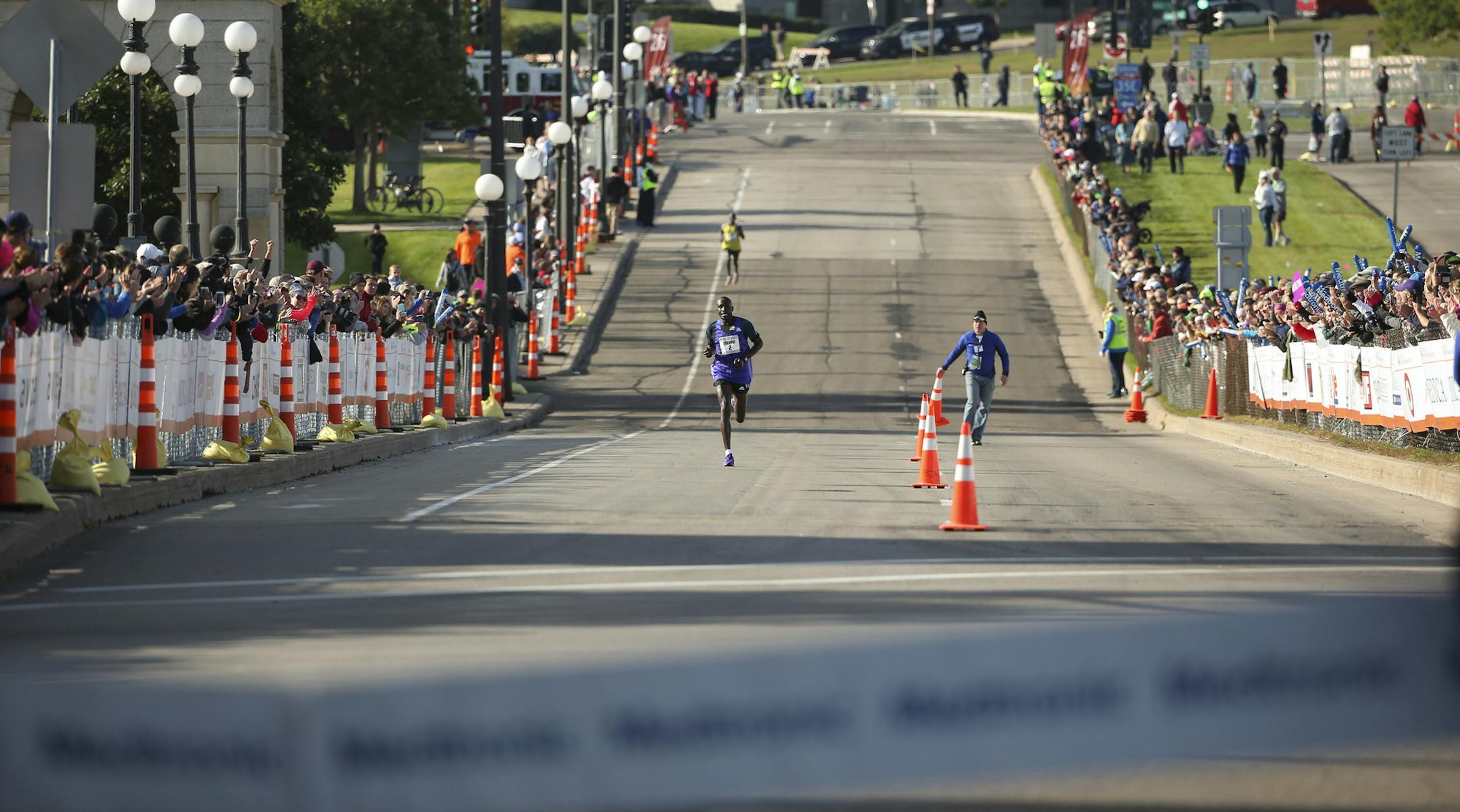 First place men's finisher Dominic Ondoro had a healthy lead over Elisha Barno as they neared the finish line Sunday morning. ] JEFF WHEELER • jeff.wheeler@startribune.com More than 11,000 runners started the Twin Cities Marathon Sunday morning, October 4, 2015 in Minneapolis.