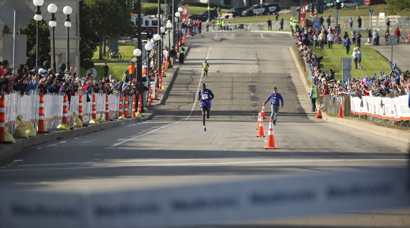 First place men's finisher Dominic Ondoro had a healthy lead over Elisha Barno as they neared the finish line Sunday morning. ] JEFF WHEELER &#x2022; jeff.wheeler@startribune.com More than 11,000 runners started the Twin Cities Marathon Sunday morning, October 4, 2015 in Minneapolis.