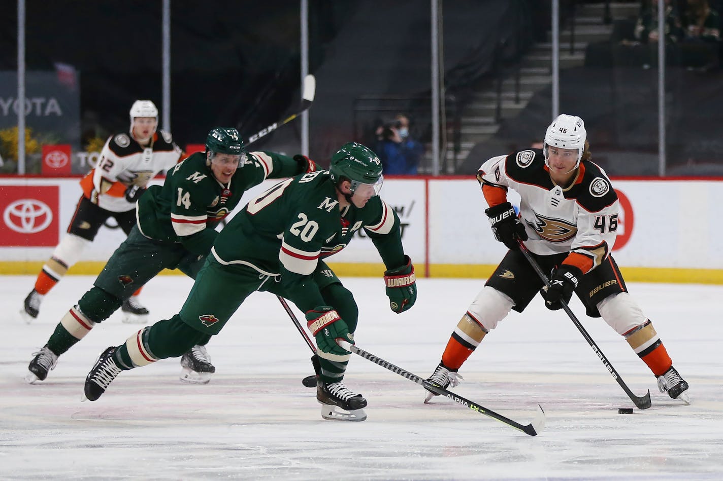 Anaheim Ducks' Trevor Zegras (46) controls the puck next to Minnesota Wild's Ryan Suter (20) during the second period of an NHL hockey game Friday, May 7, 2021, in St. Paul, Minn. (AP Photo/Stacy Bengs)