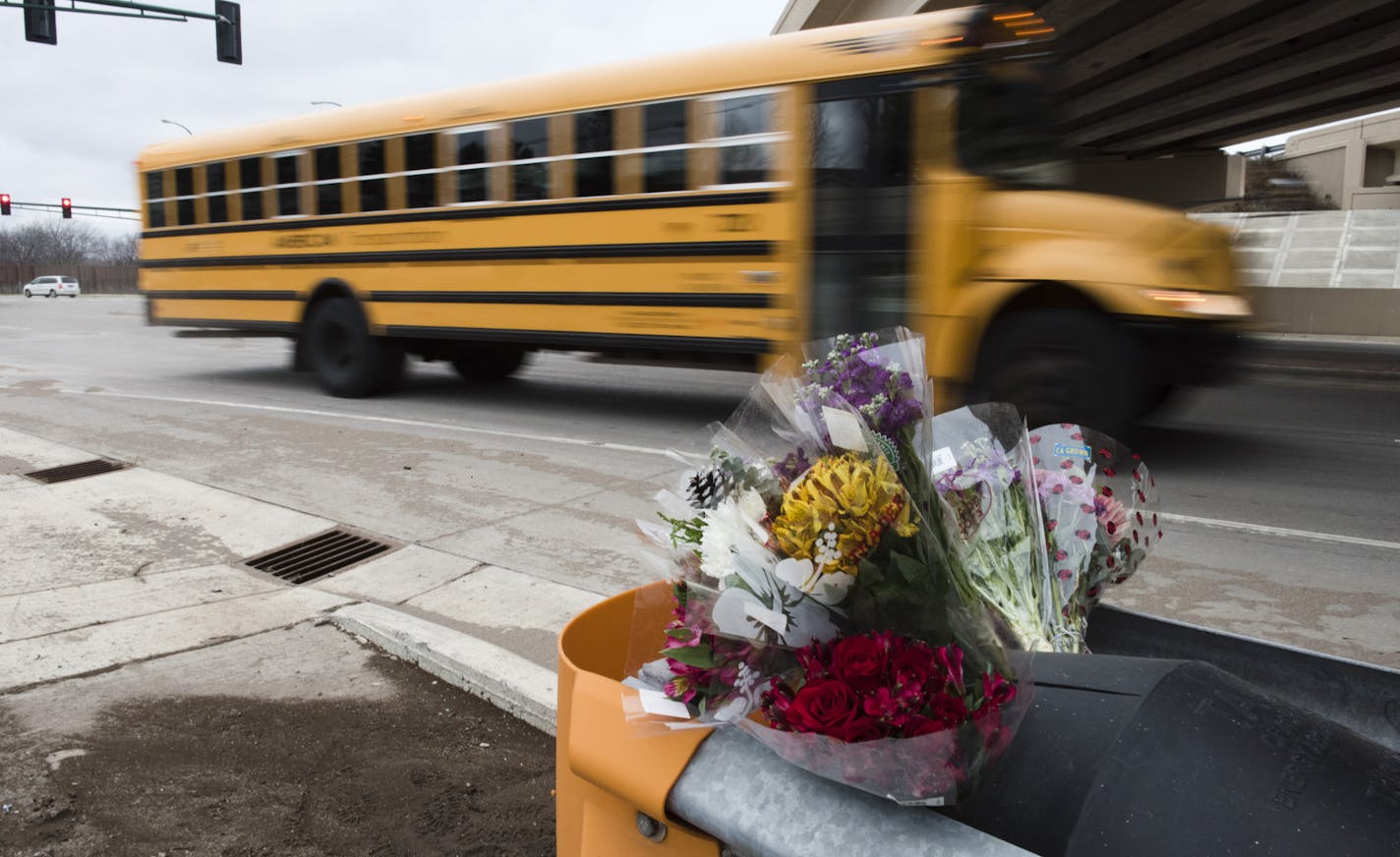 Flowers, tire tracks, and broken glass marked the scene of Thursday's fatal collision.