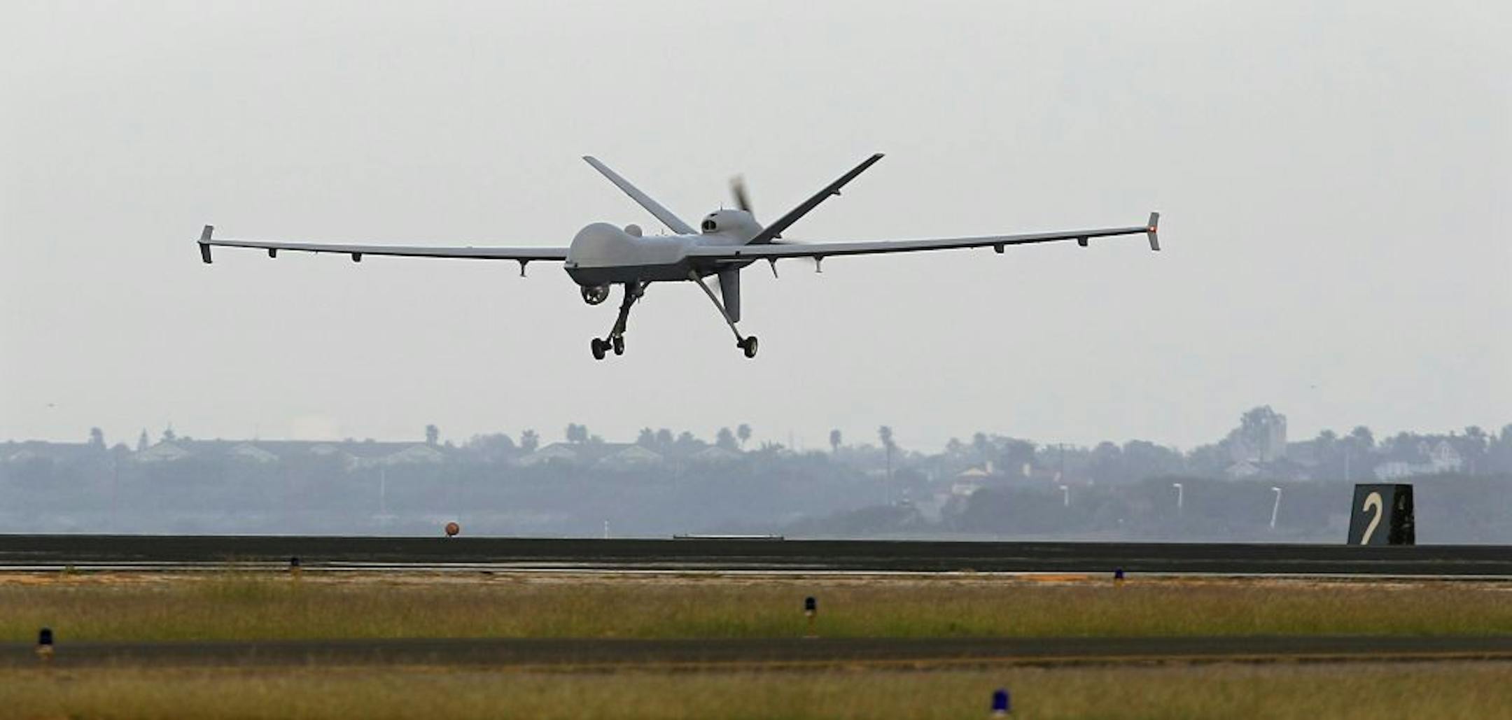 FILE - This Nov. 8, 2011 file photo shows a Predator B unmanned aircraft landing after a mission, at the Naval Air Station, in Corpus Christi, Texas