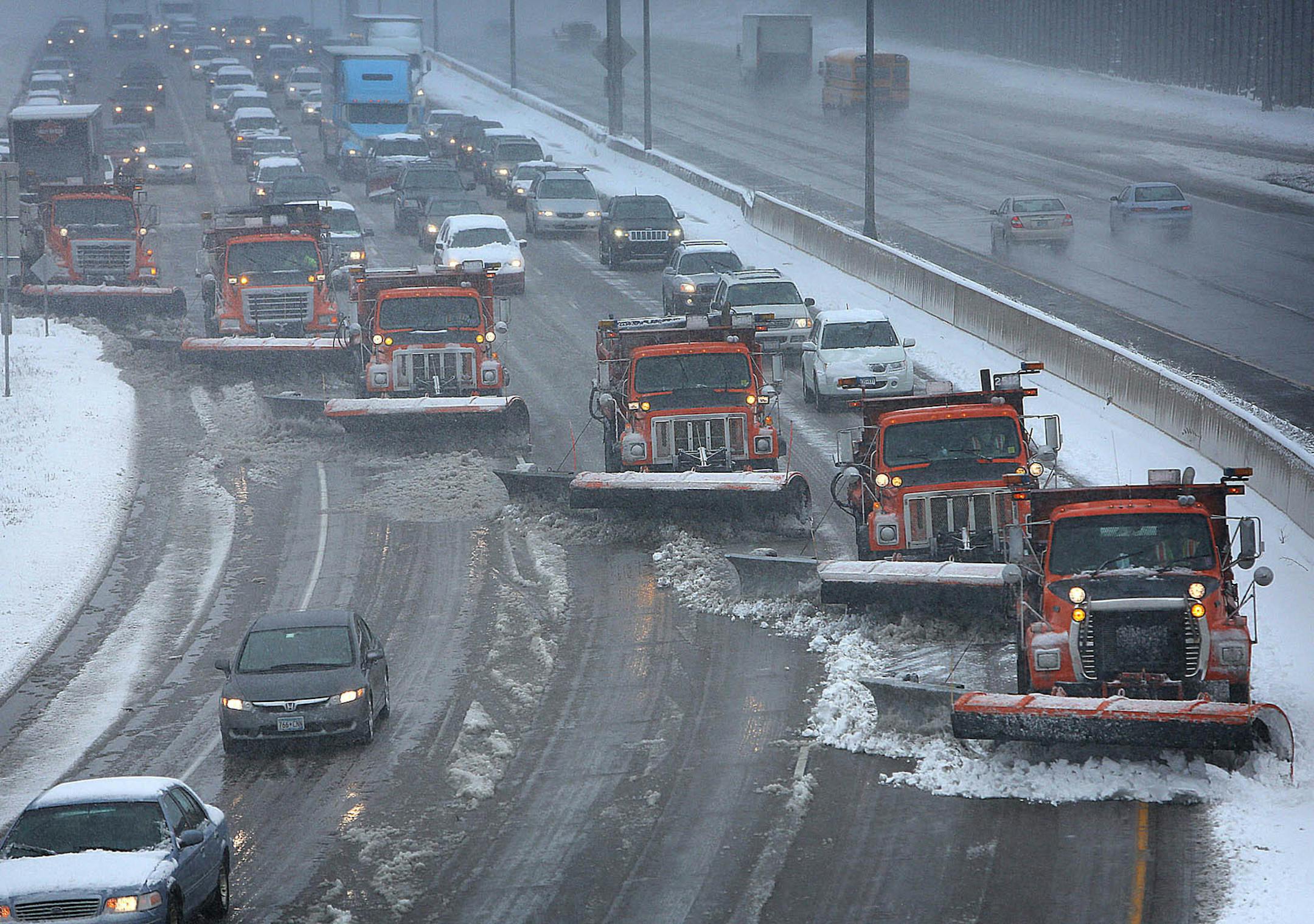 Snow plows teamed up to clear snow from the west bound lanes of Interstate 94 near Burns Ave. in St. Paul.