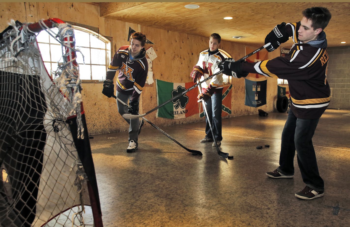 For the first time three brothers play on the UM hockey team - the Reilly boys from Chanhassen. Mike Reilly, Connor Reilly and Ryan Reilly, l-r, practiced their shots in a hocky workout area in the basement of their Chanhassen home. (MARLIN LEVISON/STARTRIBUNE(mlevison@startribune.com)