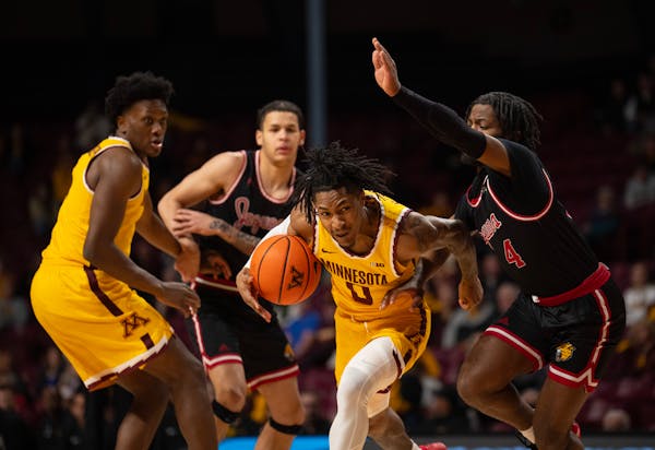 Gophers guard Elijah Hawkins (0) drove against IUPUI Jaguars guard Bryce Monroe (4) in the first half. The University of Minnesota Gophers faced the I
