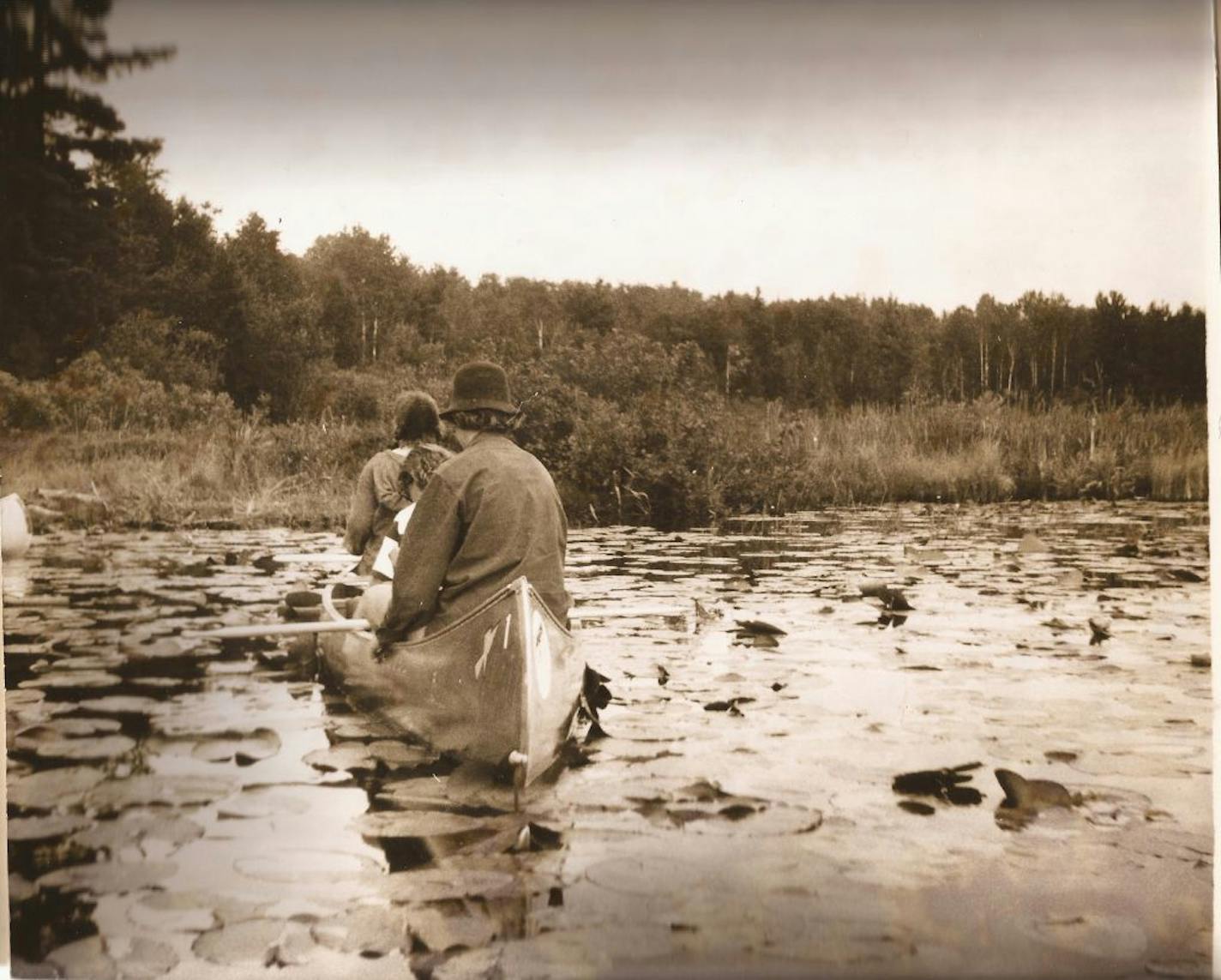 Joan Thames (stern), Pat Giebink (middle or "duffer" position) and Betty Kilanowski (bow) canoed in the Boundary Waters."Although you can't see it in this photo," Thames said, "I carried a toothbrush pushed through two holes in my felt hat, and I often dunked it in the clear water and brushed my teeth."