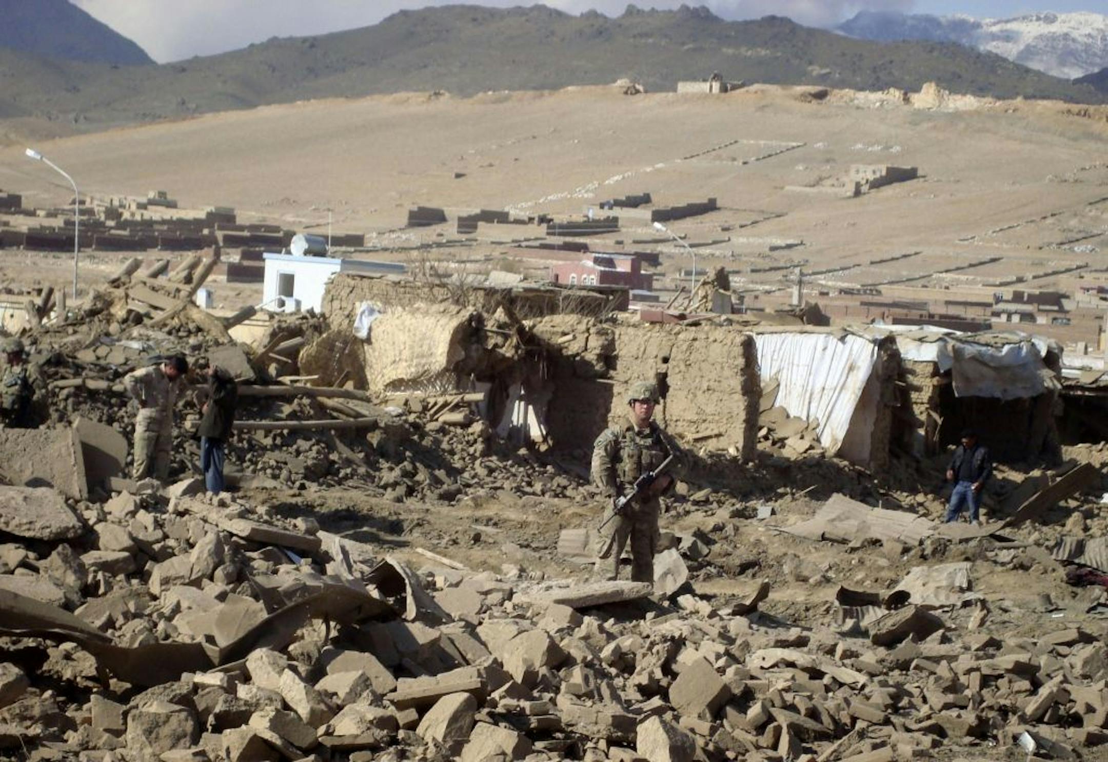 A U.S. soldier stands guard at the site of suicide attack in Wardak Province of Kabul Afghanistan, Friday, Nov, 23, 2012. A suicide attacker detonated a car laden with explosives Friday in eastern Afghanistan, killing several civilians and wounding dozens of others, officials said. Taliban spokesman Zabiullah Mujahid claimed responsibility for the bombing, saying in a statement that the attack was in response to the recent execution of four Taliban detainees at the Afghan government's main deten