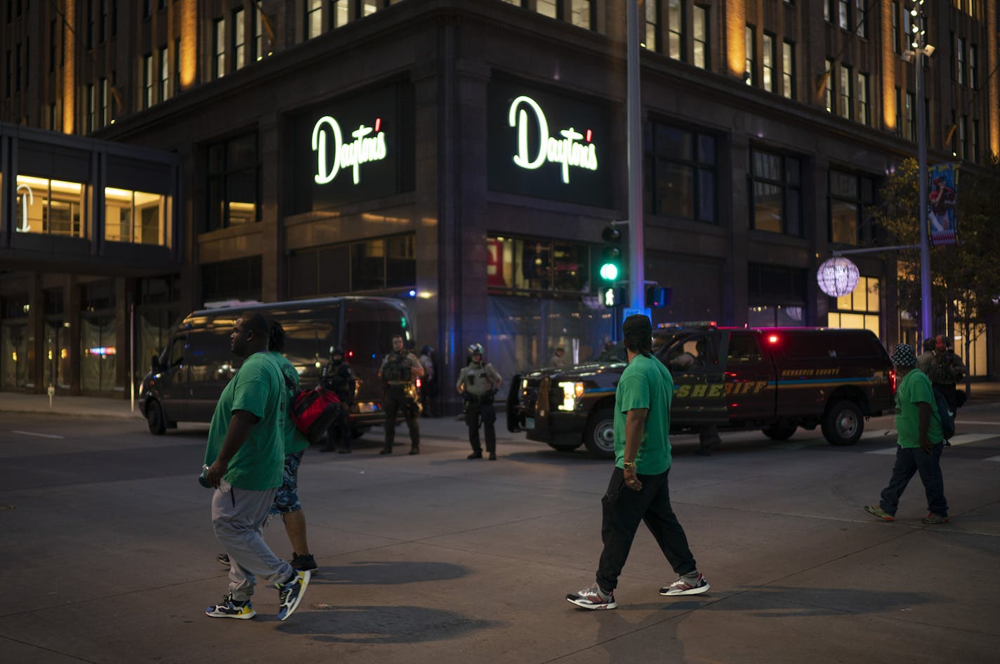 Volunteers with Mad Dads walked down the Nicollet Mall shortly after curfew fell, encouraging anyone on the streets to head home. ] JEFF WHEELER • jeff.wheeler@startribune.com With a large and visible law enforcement presence, downtown Minneapolis was calm and under curfew Thursday night, August 27, 2020, a day after store windows were broken and fires were set.