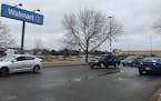 Police remained on scene as customers were allowed to leave the Brooklyn Park Walmart where officers shot a man Monday. He is expected to survive. (Ki