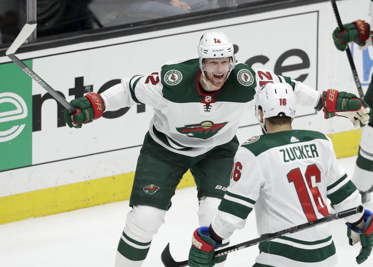 Minnesota Wild center Eric Staal, left, celebrates with left wing Jason Zucker after scoring against the Anaheim Ducks during the third period of an N