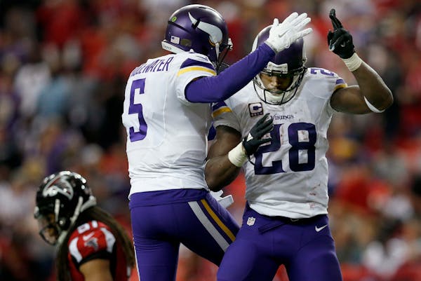 Minnesota Vikings Teddy Bridgewater (5) and Adrian Peterson (28) celebrated a 35-yard touchdown run by Peterson in the fourth quarter. ] CARLOS GONZAL