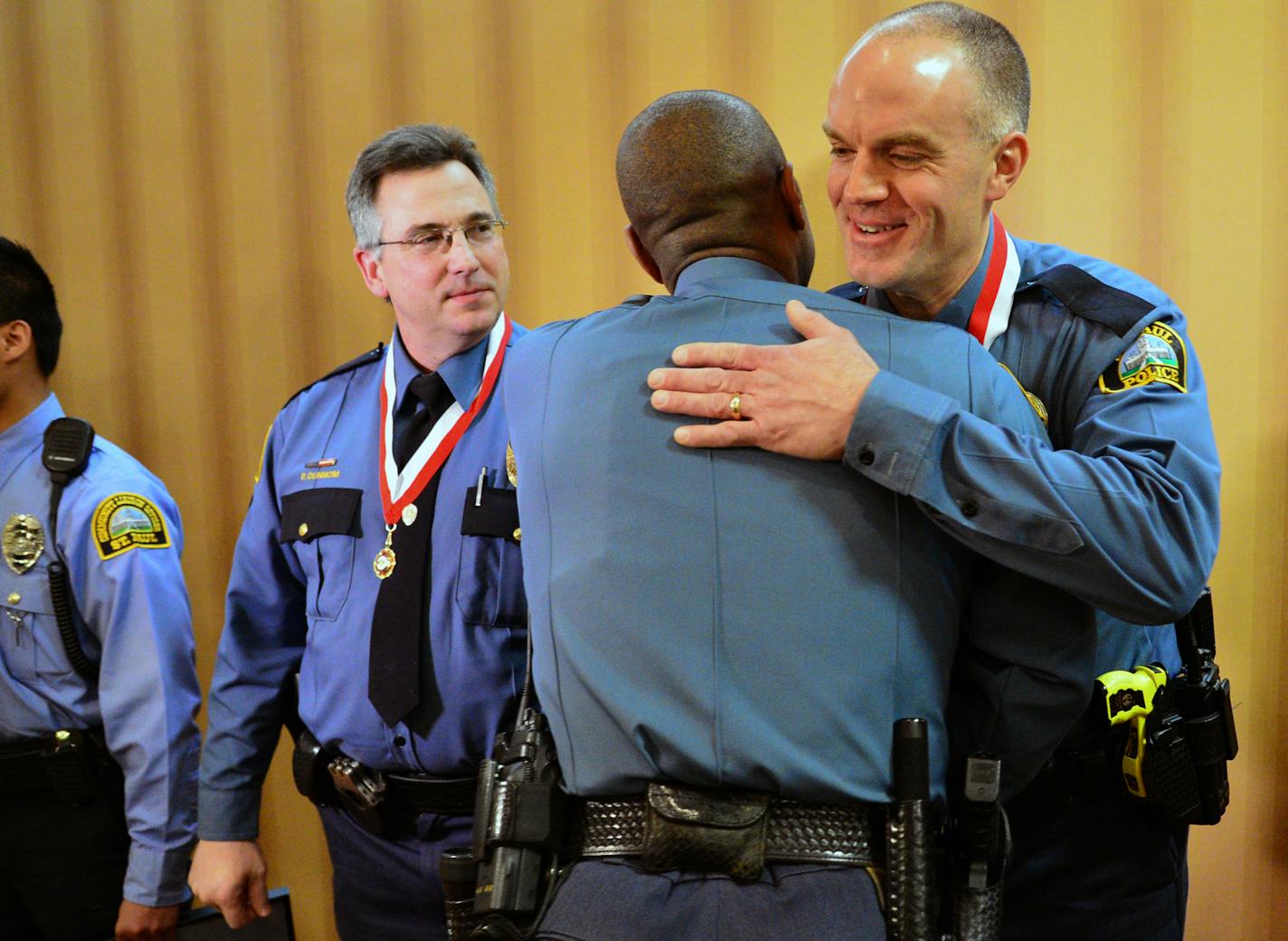 Officer Thomas Tanghe was greeted by fellow officers in a receiving line after the ceremony on the left is Sergeant Paul Dunnom who was detective of the year. ] St. Paul police gave their Officer of the Year award at the Holiday Inn In St Paul. Officer Thomas Tanghe was awarded the officer of the year for focusing on improving quality of life in high crime areas. Richard.Sennott@startribune.com Richard Sennott/Star Tribune St Paul , Minn. Friday 3/25/2014) ** (cq)