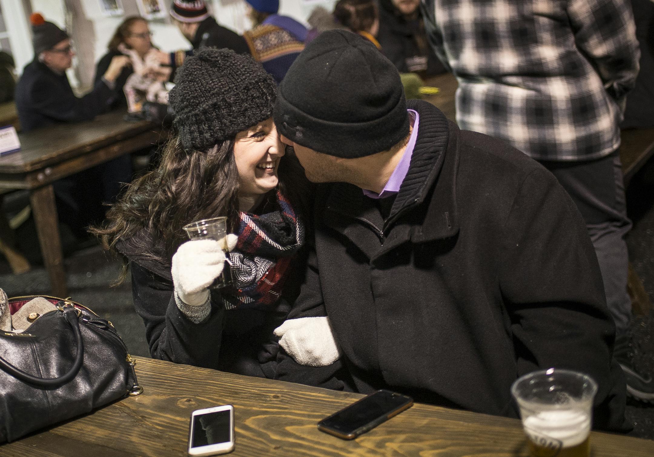 Callie Harp of Hastings and Jake Koehler of Elk River shared a moment over drinks in the warming house at Holidazzle on Friday night.