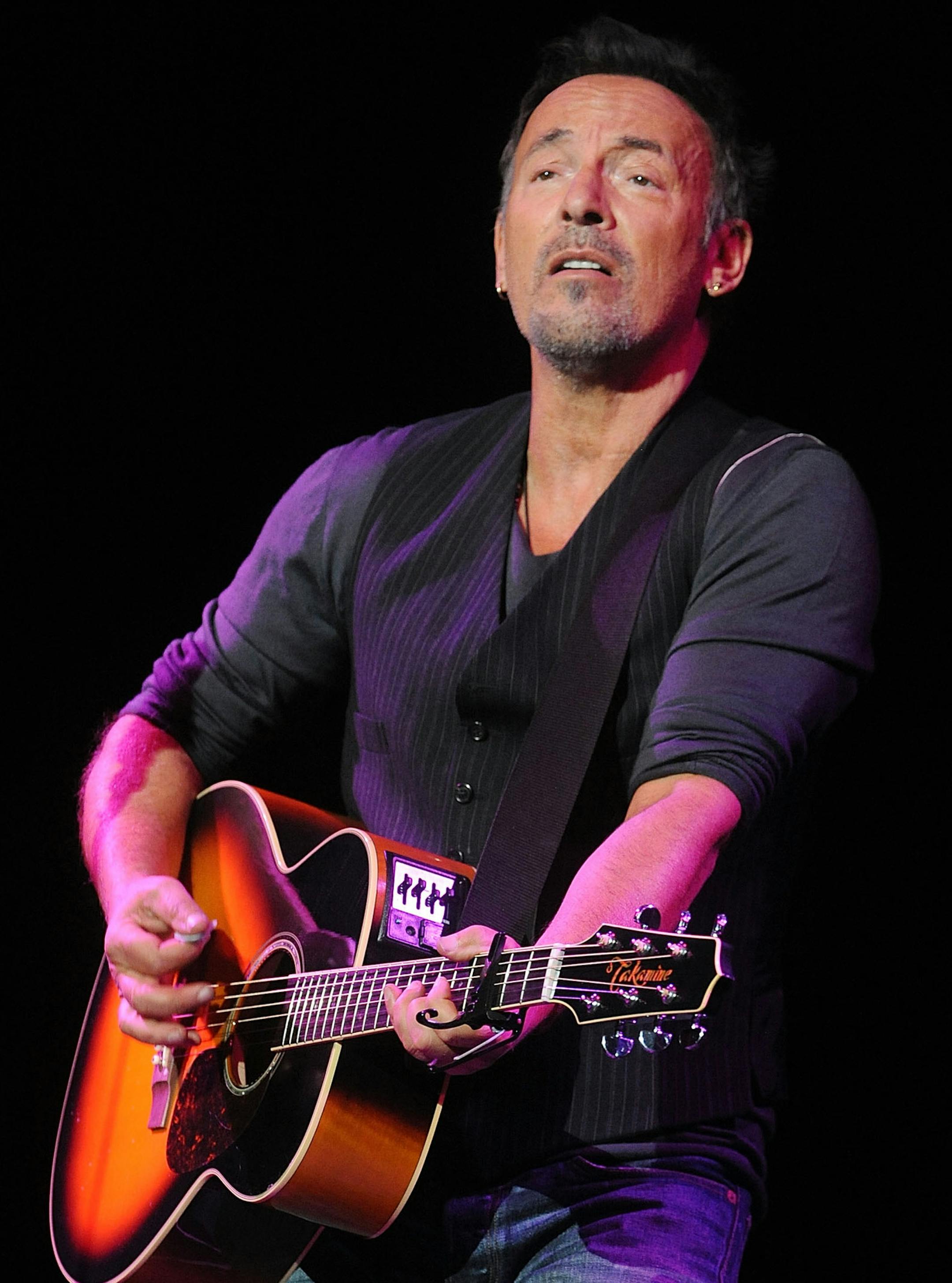 Bruce Springsteen performs at the 8th Annual Stand Up For Heroes, presented by New York Comedy Festival and The Bob Woodruff Foundation, at the Theater at Madison Square Garden on Wednesday, Nov. 5, 2014, in New York. (Photo by Brad Barket/Invision/AP)