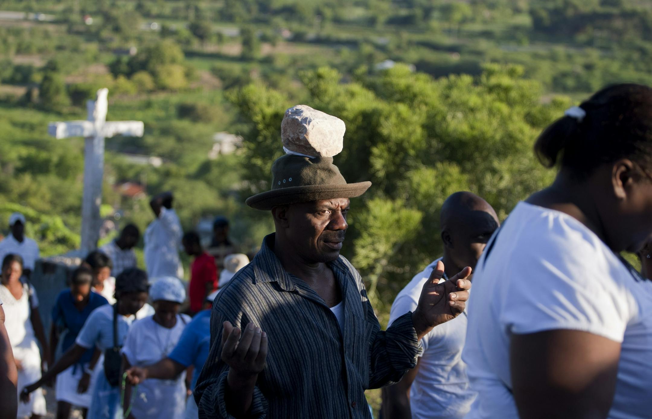 A man prays as he balances a stone on his head as a form of penance during a Good Friday pilgrimage to Morne Calvaire Miracle, in Ganthier, Haiti, Friday, April 3, 2015. Thousands of devout Haitians travel to the small town east of Port-au-Prince on Good Friday, hike across the surrounding mountains, visiting the Stations of the Cross, or depictions of Jesus Christ's final journey to his crucifixion at Calvary. (AP Photo/Dieu Nalio Chery)