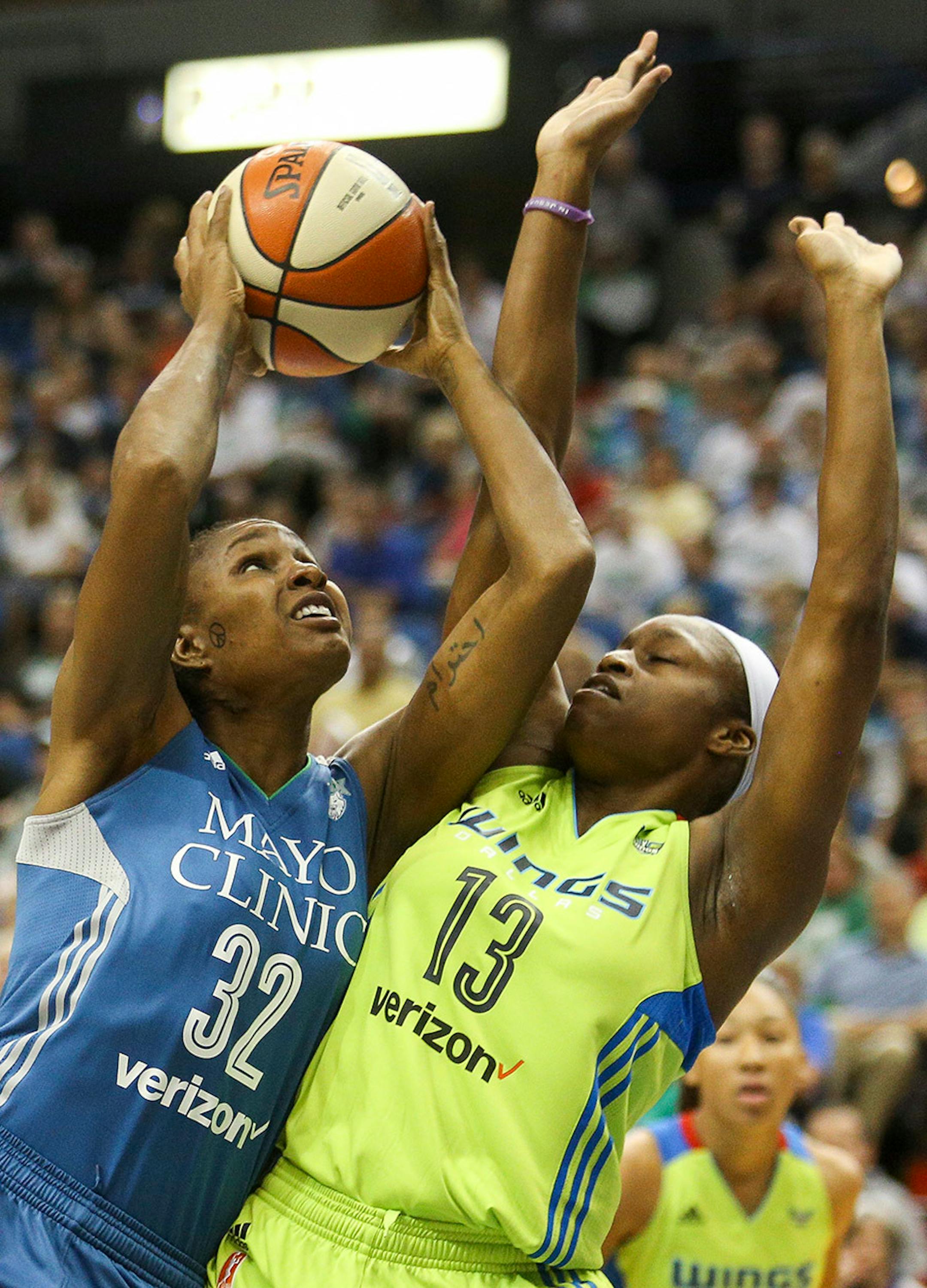 Minnesota Lynx forward Rebekkah Brunson (32) drives past Dallas Wings forward Karima Christmas (13).