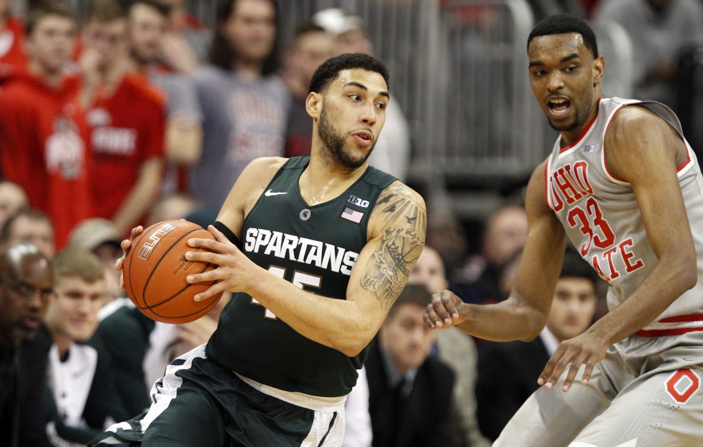 Michigan State's Denzel Valentine, left, works against Ohio State's Keita Bates-Diop during an NCAA college basketball game in Columbus, Ohio, Wednesday, Feb. 23, 2016. Michigan State won 81-62. (AP Photo/Paul Vernon)