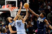 Memphis Grizzlies forward Brandon Clarke (15) has his shot block by Minnesota Timberwolves guard Anthony Edwards (1) with defensive help from center R