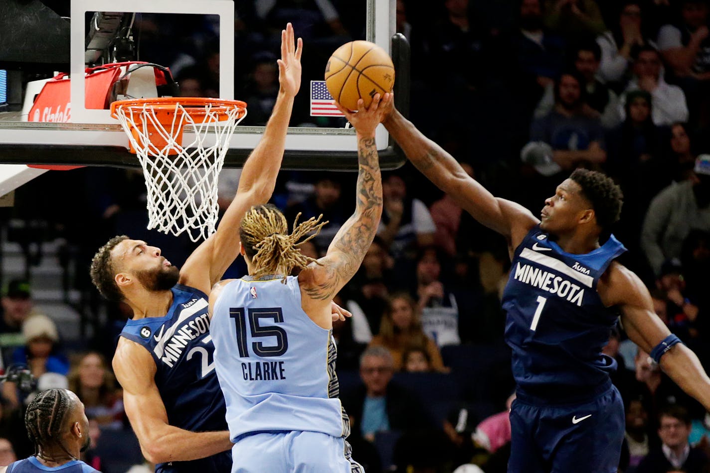 Memphis Grizzlies forward Brandon Clarke (15) has his shot block by Minnesota Timberwolves guard Anthony Edwards (1) with defensive help from center Rudy Gobert (27) in the third quarter of an NBA basketball game Wednesday, Nov. 30, 2022, in Minneapolis. (AP Photo/Andy Clayton-King)