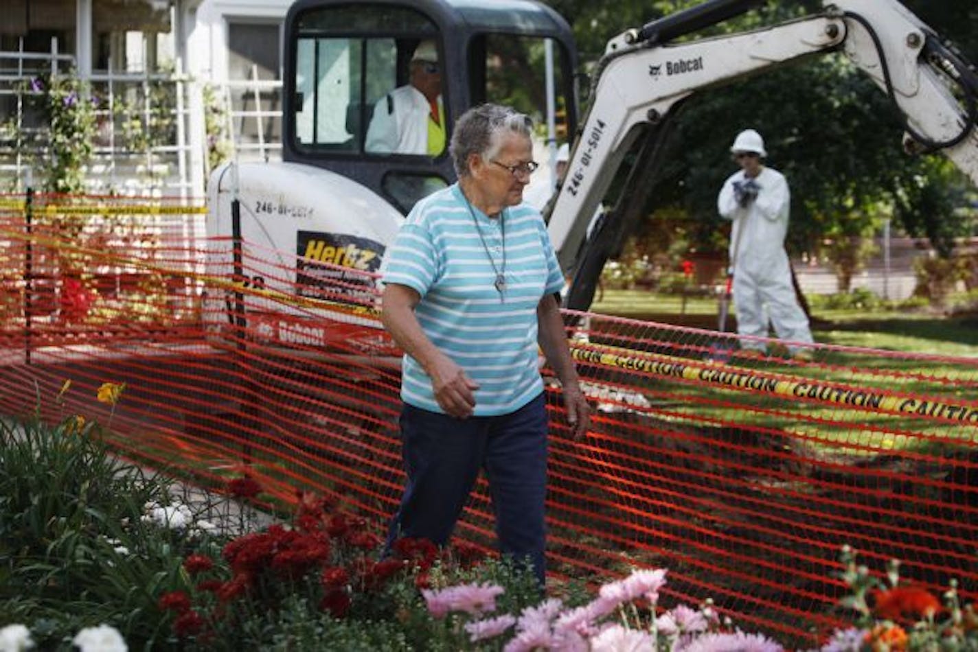 At her home in South Minneapolis where she has lived for the past 57 years, Meryl Miller,89, walks past her prized flowers and the dug up lawn that contractors for the EPA are removing because of arsenic contamination from a long-closed pesticide storage area nearby. "I was shocked when I found out about it. I raised three boys here," says Miller. About 480-500 homes in the area have been fastracked for cleanup thanks to funds from the Obama administration.