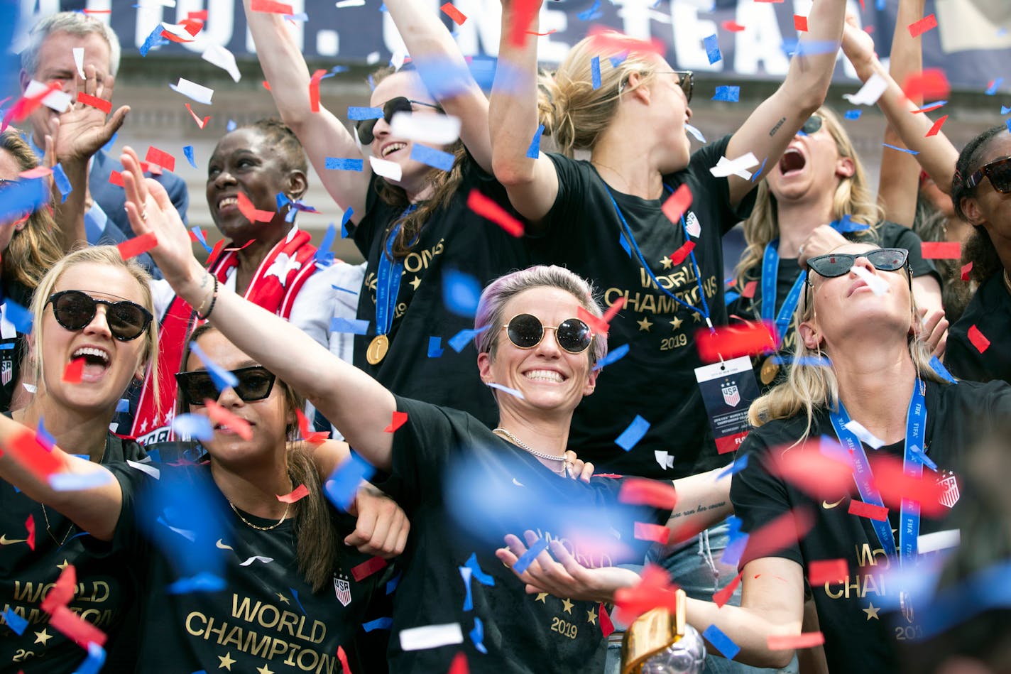 Megan Rapinoe, center, is joined by teammates on the U.S. women's national soccer team during a celebratory rally at City Hall following a ticker-tape parade in New York