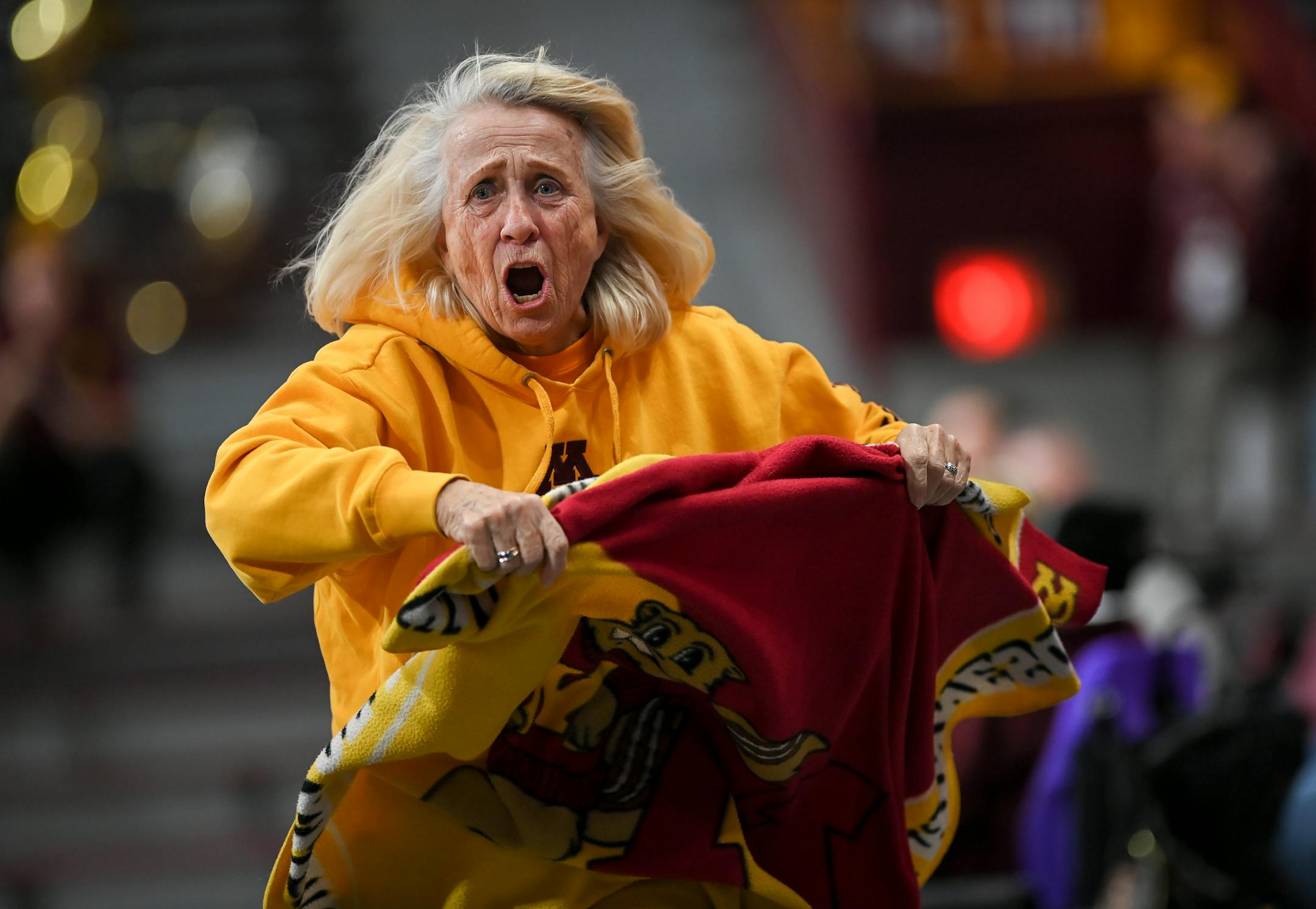 Elvera "Peps" Neuman, of Clearwater, rallies Gophers fans against Wake Forest during the second half.