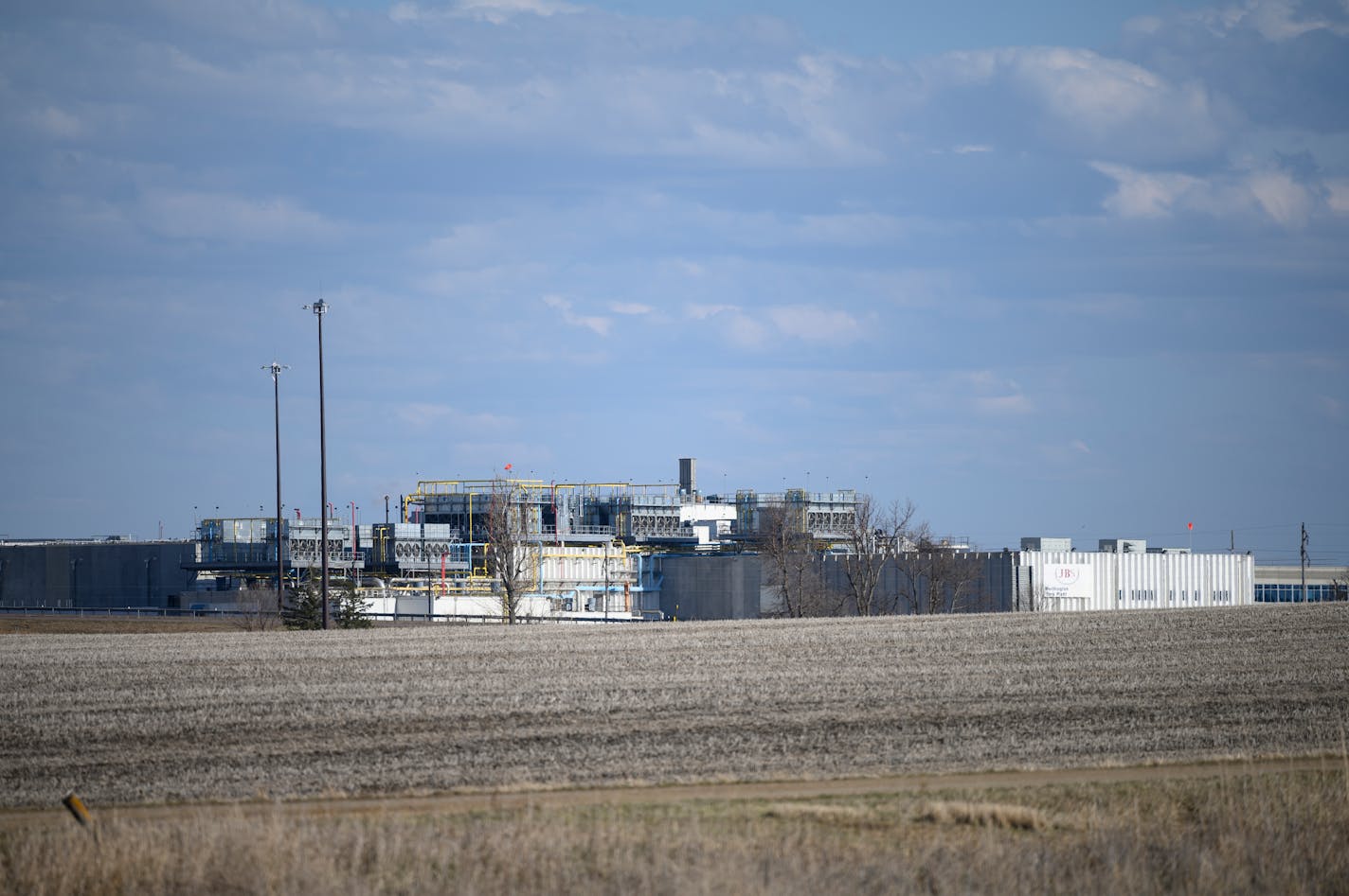 This photo taken April 18, 2020, shows the JBS USA Pork Plant in Worthington, Minn. For weeks, Al Oberloh and others living in this meatpacking town of 10,000 people braced themselves for what they believed was inevitable: an outbreak of the deadly COVID-19. On Friday, their fears were confirmed. At least 19 cases were confirmed at the JBS pork plant here, an hour east of the Smithfield Foods pork plant in Sioux Falls, which was shut down last week when nearly 300 workers were infected with the disease. Now with a foothold in Worthington, a city of 10,000 people, communities across southwestern Minnesota are on edge. "It was just a matter of time," said Oberloh, a City Council member and former mayor. "We're a packinghouse town. We have 2,000 people who work shoulder to shoulder." (Aaron Lavinsky/Star Tribune via AP) ORG XMIT: MER8ae8e6f9843f3bb547e850f18d4ca