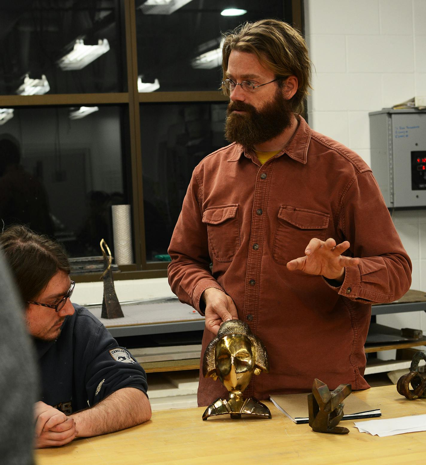 Aaron Dysart discussed a student project in his sculpture class at Anoka-Ramsey Community College. Dysart has been teaching at the college for nine years. Photo by Liz Rolfsmeier