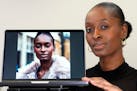 Fashion model Alexsandrah poses with a computer showing an AI generated image of her, in London, Friday, March 29, 2024.