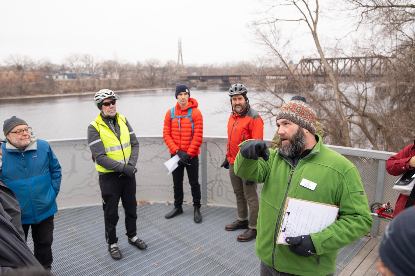 Tyler Pederson, Design Project Manager with the Minneapolis Park and Recreation Board, leads a site visit and Q&A with local residents about building a pedestrian bridge across the Mississippi River Saturday, Feb. 03, 2024, at The Overlook at 26th Ave. N. in Minneapolis, Minn.     ]

ALEX KORMANN • alex.kormann@startribune.com