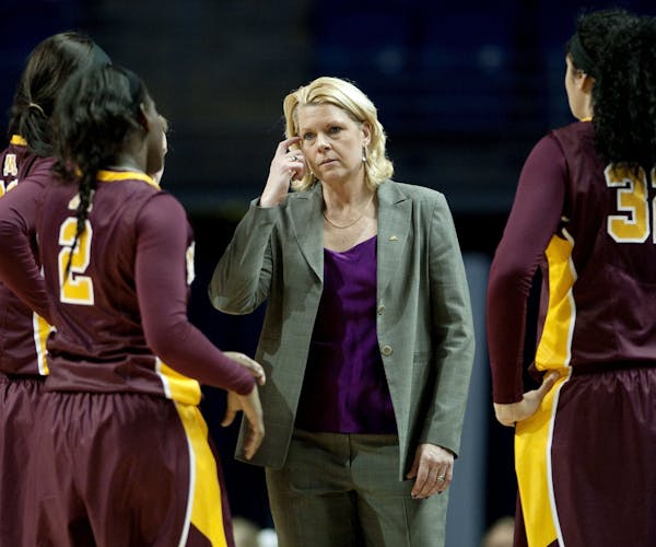 Minnesota head coach Pam Borton talks to her players during a women's college basketball game at the Bryce Jordan Center in State College, Pa., on Sun