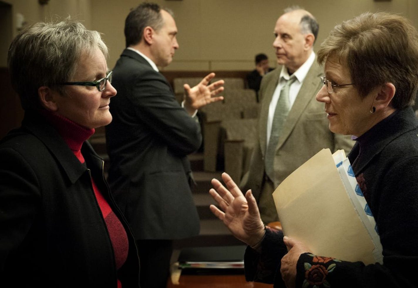 State Budget Director Margaret Kelly and Minnesota Management and Budget Commissioner Jim Schowalter, left talked with legislators Joe Mullery (DFL) and Alice Hausman (DFL) , after the hearing where they testified before the House Ways and Means committee Monday, January 28, 2013 on Governor Dayton's budget.