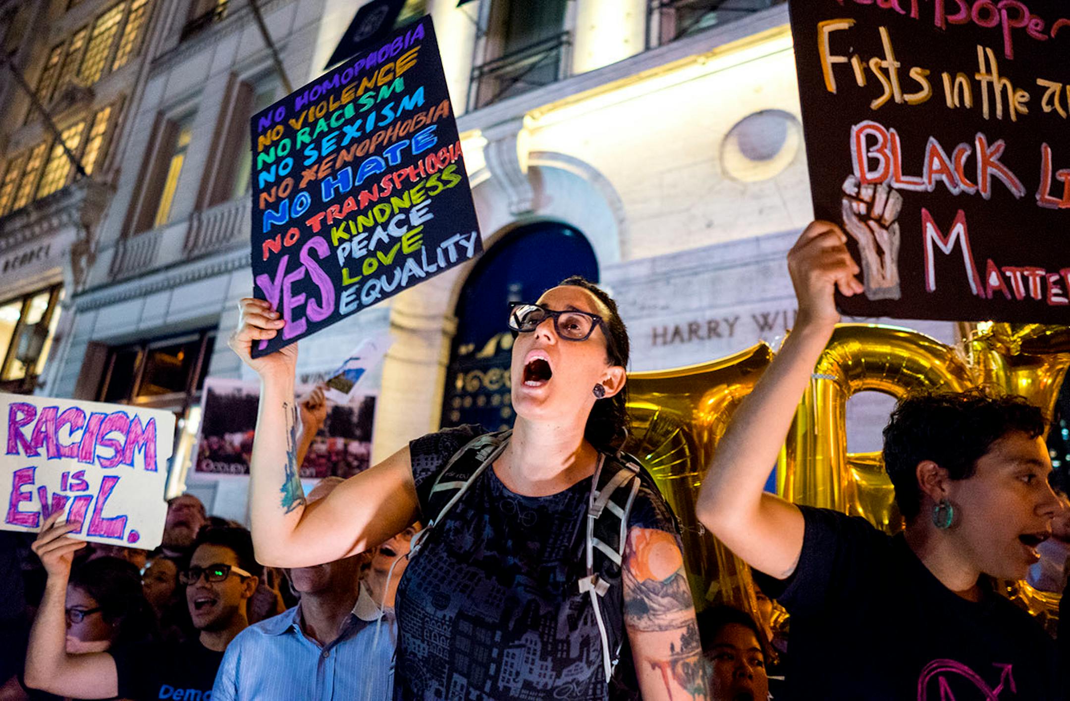 Protestors near Trump Tower react as President Donald Trump arrives, Monday, Aug. 14, 2017, in New York. (AP Photo/Craig Ruttle)