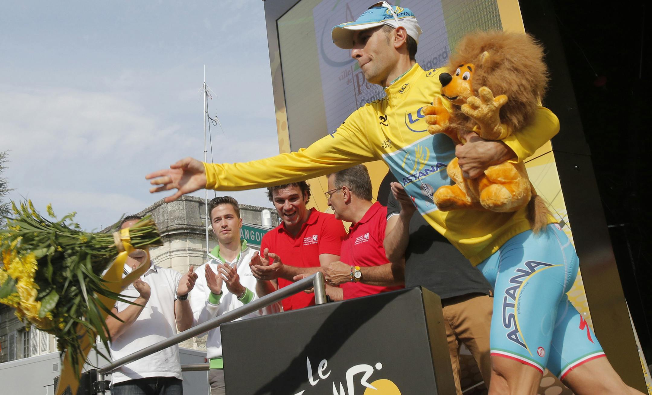 Italy's Vincenzo Nibali, wearing the overall leader's yellow jersey, celebrates on the podium of the twentieth stage of the Tour de France cycling race, an individual time-trial over 54 kilometers (33.6 miles) with start in Bergerac and finish in Perigueux, France, Saturday, July 26, 2014. (AP Photo/Christophe Ena)