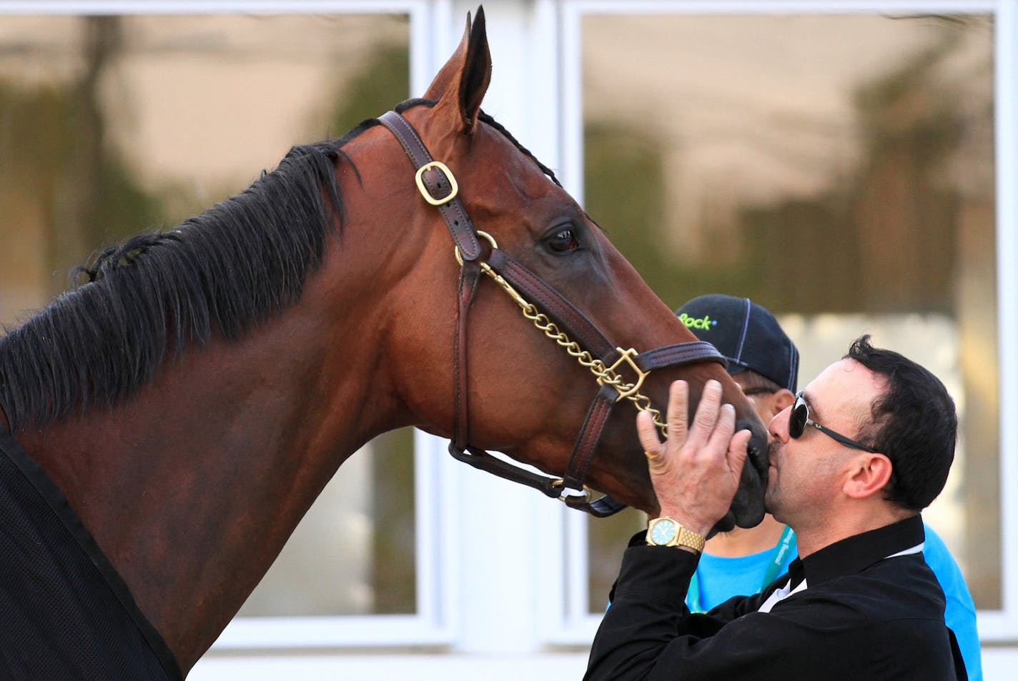 Exercise rider Jorge Alvarez kisses American Pharoah on the nose after American Pharoah won the 147th running of the Belmont Stakes horse race to win the first Triple Crown in 37 years at Belmont Park, Saturday, June 6, 2015, in Elmont, N.Y. (AP Photo/Garry Jones)