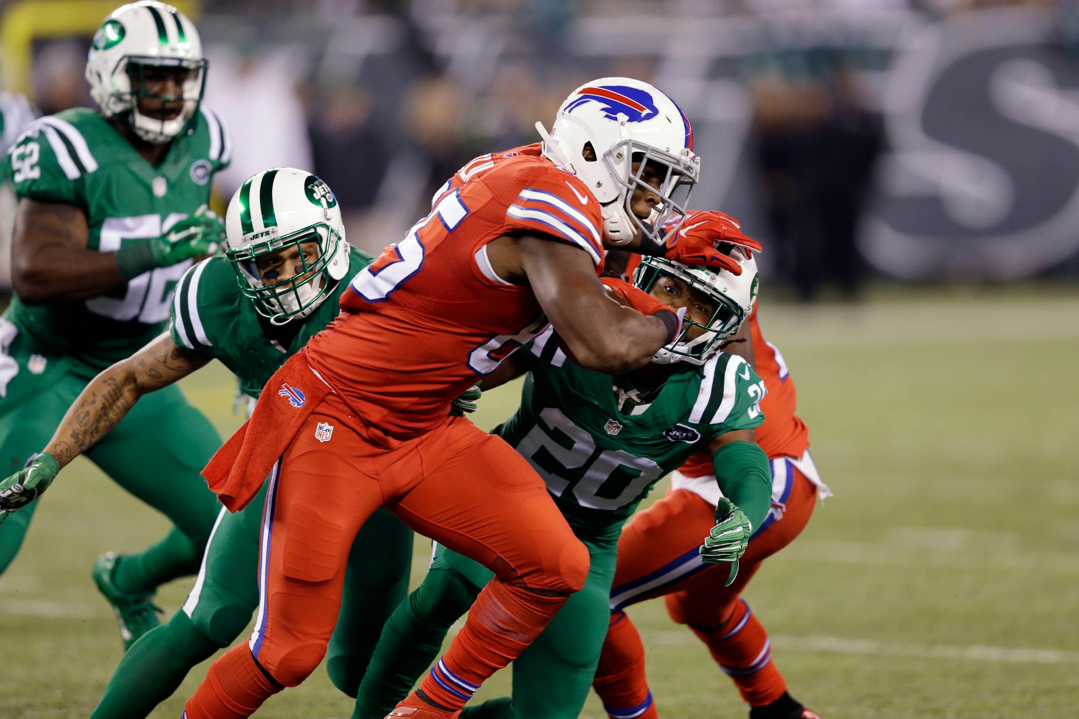 Buffalo Bills tight end Charles Clay, center, avoids a tackle by New York Jets strong safety Marcus Williams (20) during the second half of an NFL football game, Thursday, Nov. 12, 2015, in East Rutherford, N.J.
