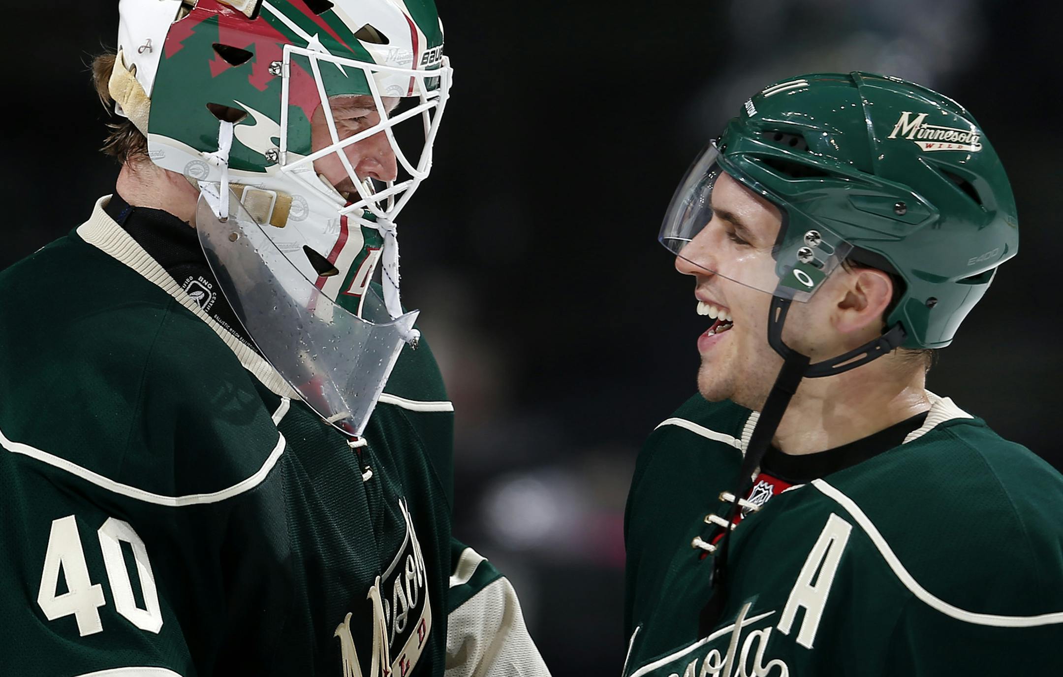 Minnesota Wild goalie Devan Dubnyk (4) and Zach Parise celebrated at the end of the game. Minnesota beat Chicago by a final score of 3-0. ] CARLOS GONZALEZ cgonzalez@startribune.com, February 3, 2015, St. Paul, Minn., Xcel Energy Center, NHL, Minnesota Wild vs. Chicago Blackhawks ORG XMIT: MIN1502041426180093