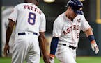 Houston Astros' Alex Bregman, right, celebrated his solo home run off Twins starter Kyle Gibson with third base coach Gary Pettis during the first inn