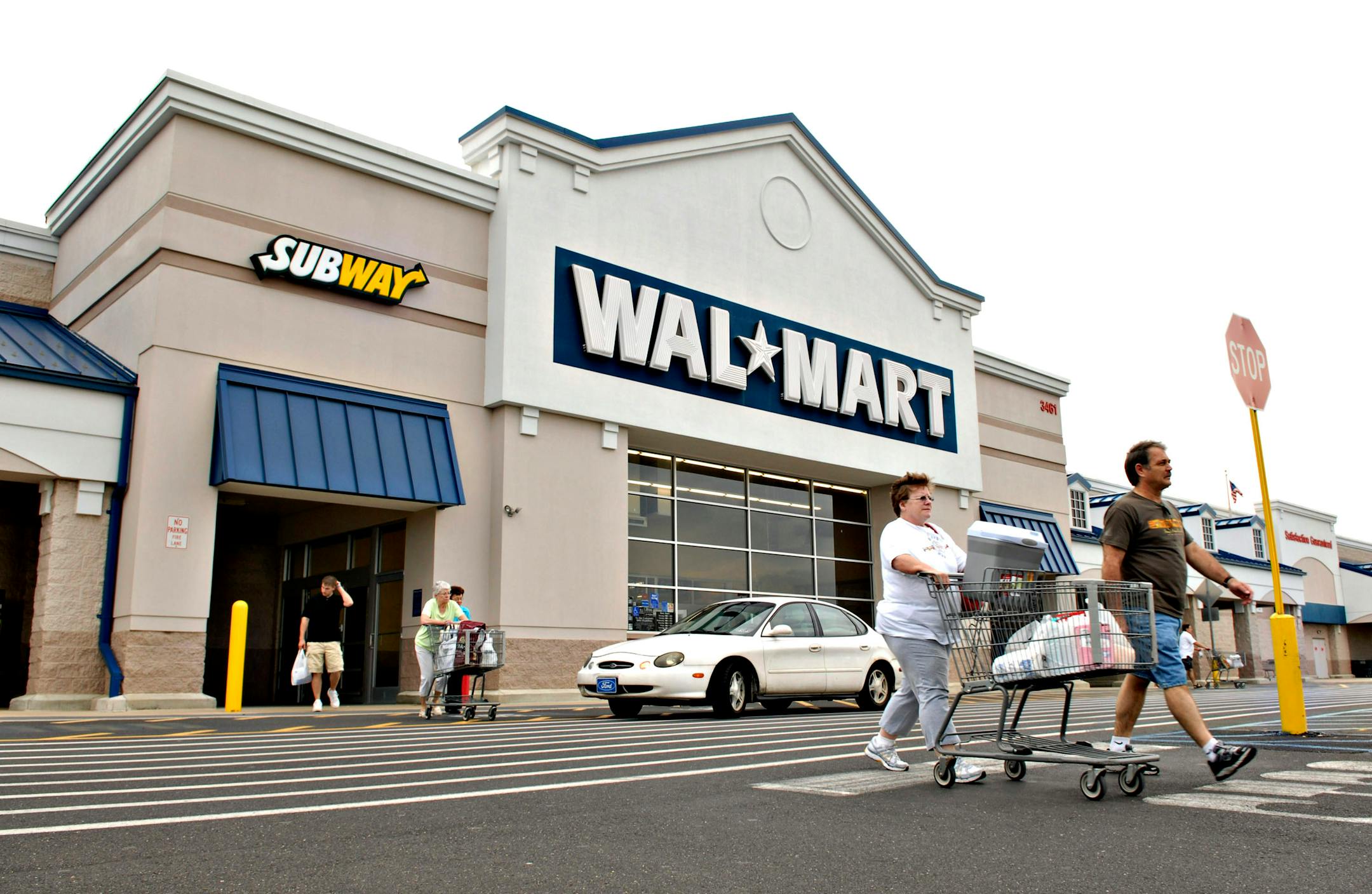 Wal-Mart pays its workers slightly less than the average in retailing, but its low prices save consumers hundreds of dollars a year, a study finds.