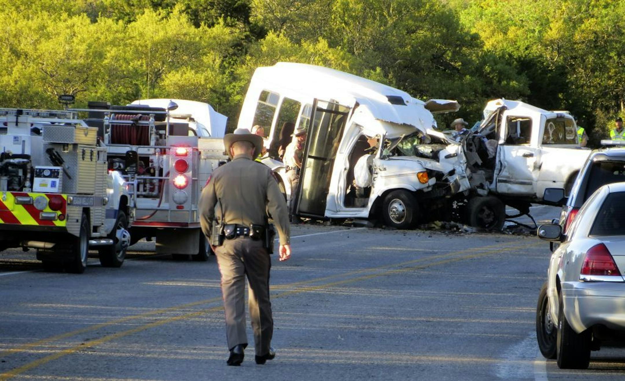 Authorities investigate after a deadly crash involving a van carrying church members and a pickup truck on U.S. 83 outside Garner State Park in northern Uvalde County, Texas, Wednesday, March 29, 2017. The group of senior adults from First Baptist Church of New Braunfels, Texas, was returning from a retreat when the crash occurred, a church statement said.