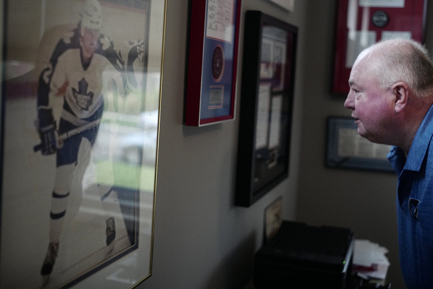 At his home in Woodbury, Wild coach Bruce Boudreau studied himself in a photograph from his days with the Toronto Maple Leafs. Boudreau played in 141 games in the NHL.