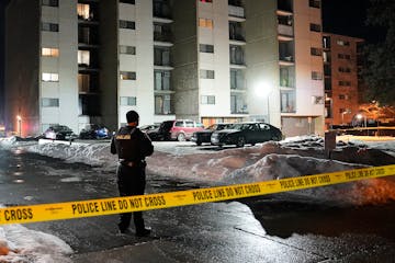 A St. Paul police officer stood guard outside an apartment complex on the 100 block of Western Avenue in St. Paul on Feb. 11, 2023.