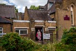 A woman exits a polling station set up at St. Anne's Church, Bermondsey, in London, Thursday, July 4, 2024. Voters in the U.K. are casting their ballo