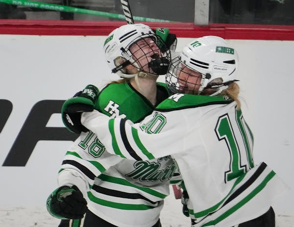 Hill-Murray Pioneers forward Chloe Boreen (18) celebrated a second period goal against Roseau with teammate Sophie Olson (10) during a Class 2A Girls 