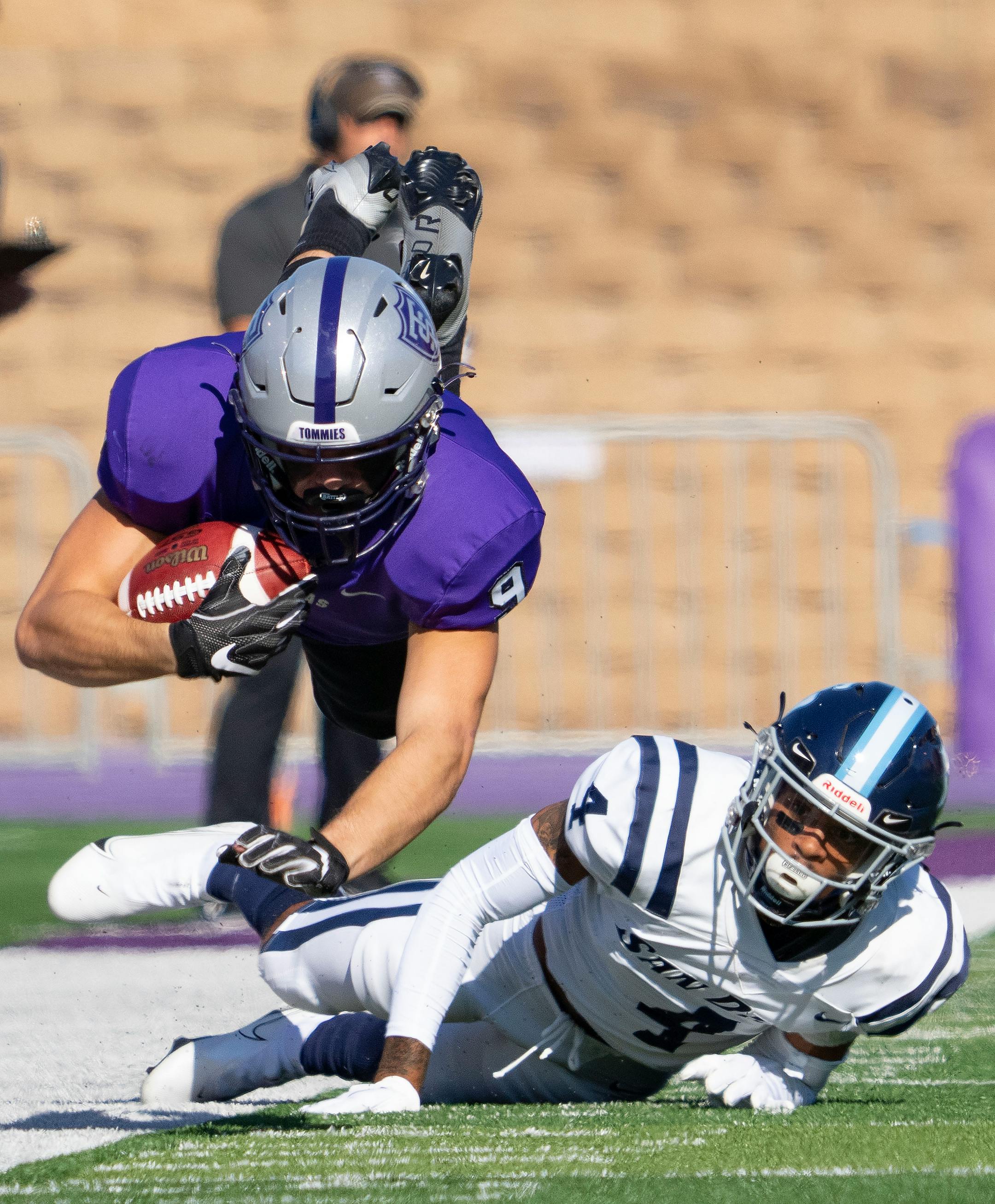 St. Thomas wide receiver Jacob WIldermuth (9) is tackled by San Diego Toreros cornerback Zamir Wallace (4) in the first quarter.