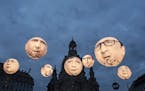Activists of the international campaigning and advocacy organization ONE install illuminated balloons with portraits of the G7 heads of state in front